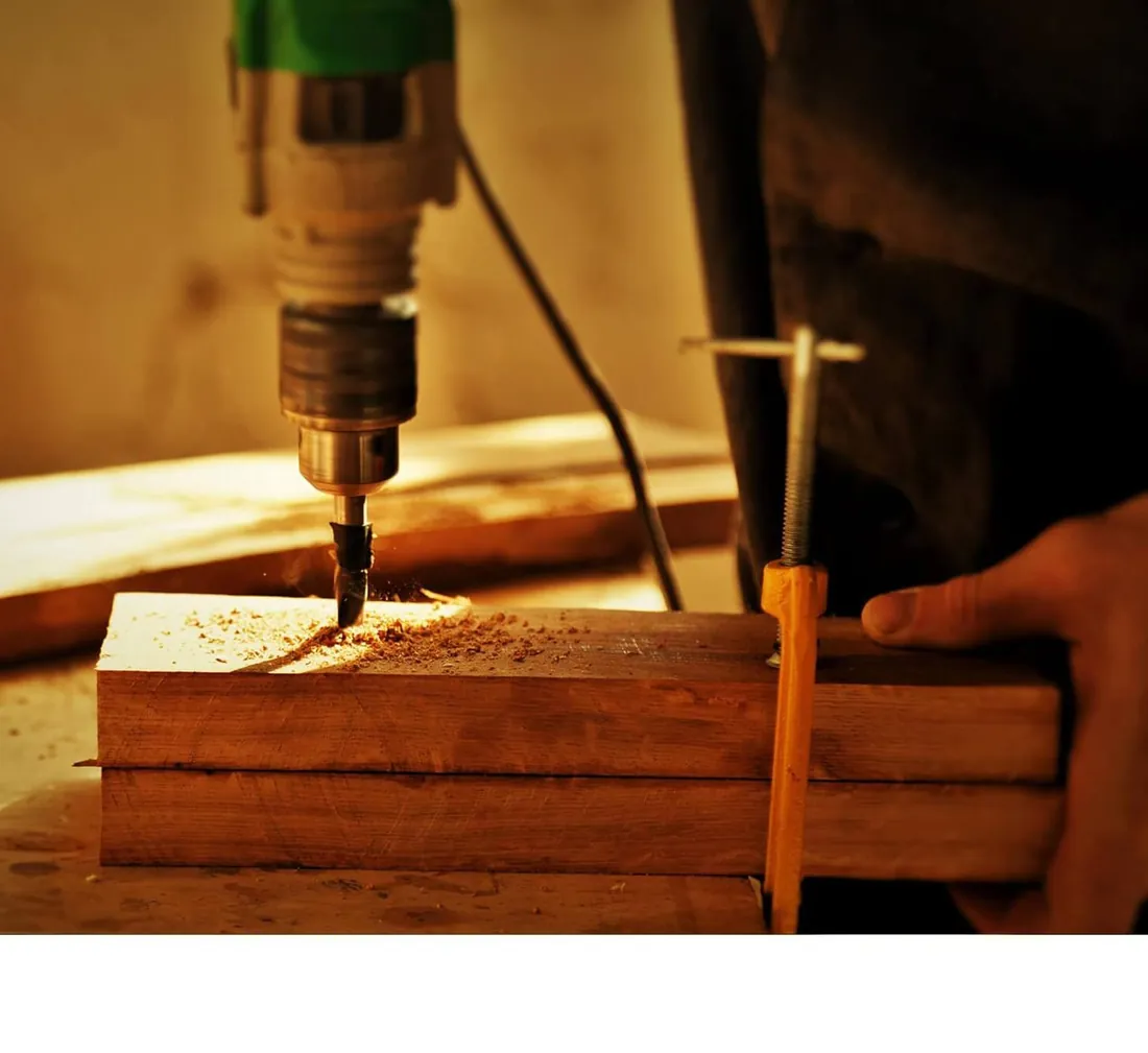 A craftsman fitting a teak joint at the Fine Shine Furniture workshop.